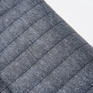 Detail of premium grey quilted PU leather with fine twill texture and parallel stitching