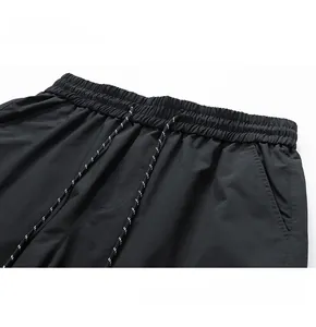 Detail of high-elastic waistband with polka dot drawstring on functional cargo pants