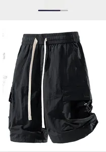 Detail of waterproof cargo shorts featuring elastic waist and heavy white drawstring