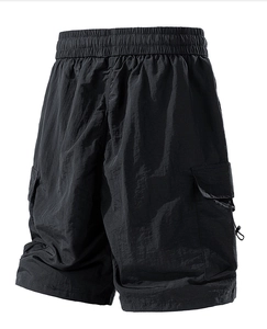 Detail of black water-repellent cargo shorts with elastic waist and side pocket drawstring