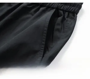 Detail of high-street cargo pants showing water-repellent fabric and elastic waistband