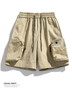 Detail of khaki techwear cargo shorts featuring a 3D pocket with breathable mesh and metal eyelet