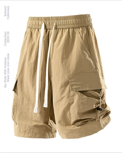 Detail of khaki cargo shorts showing elastic drawstring waist and tactical side pockets