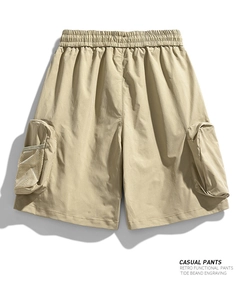 Detail view of khaki utility shorts with elastic waistband and mesh cargo pockets