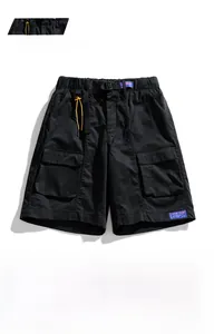 Detail of black cargo shorts featuring elastic waist with buckle belt and large pockets
