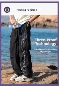 Waterproof and oil-repellent tech fabric detail on black lightweight outdoor cargo pants