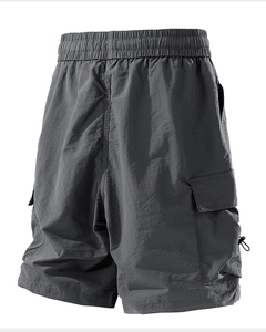 Detailed macro view of gray water-repellent cargo shorts with side pocket and drawstring