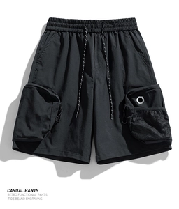 Detail shot of men's utility shorts showing tactical pockets and metallic mesh eyelets