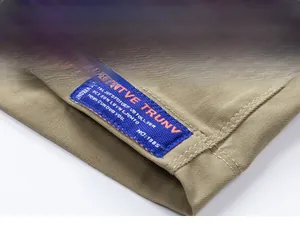 Close-up of khaki cargo shorts leg opening with blue woven label and neat stitching