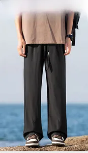 Close-up of black loose-fit hiking trousers with elastic drawstring waist detail
