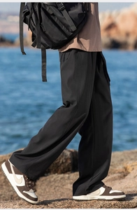 Close-up of black straight-leg cargo pants for men with smooth hiking fabric