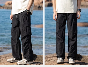 Close-up of black cargo pants featuring functional pockets and lightweight outdoor fabric