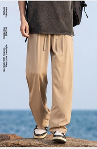 Relaxed fit khaki ice silk pants detail with drawstring waist on a beach background
