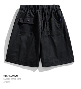 Detail of black cargo shorts featuring elastic waistband and buttoned back pockets