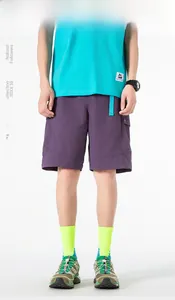 Detail of purple quick-dry cargo shorts with blue-green belt and side utility pockets