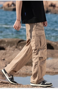 Macro detail of khaki cargo pants with large side flap pocket on textured fabric
