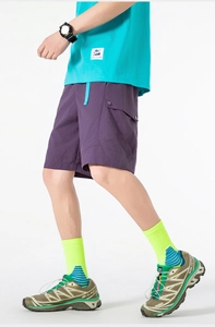 Detail of dark purple cargo shorts featuring utility pockets and blue contrast drawstrings