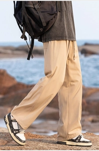 Close-up of khaki drawstring leisure pants with a straight-leg drape and ice silk fabric