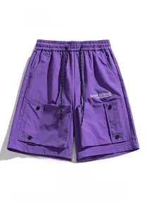 Detail of purple cargo shorts featuring elastic drawstring waist and large 3D utility pockets