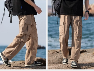 Detail of khaki outdoor trousers featuring large side cargo pockets and drawstring waist
