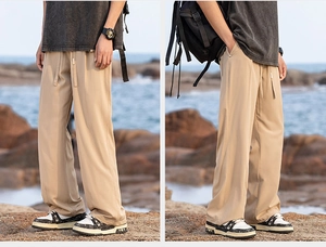 Detail of light khaki wide-leg pants with elastic drawstring waist and ice silk texture