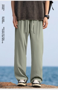 Detail of sage green drawstring ice silk pants with metal-tipped cords for hiking