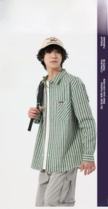 Detail of green and white striped shirt showing high-quality denim jacquard fabric texture