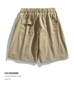 Close-up of khaki cargo shorts showing elastic drawstring waist and large rear pockets