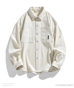 Close-up of cream corduroy shirt jacket featuring dual chest pockets and fine rib texture