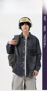 Detail of dark wash denim shirt with contrast stitching and white cross pocket embroidery