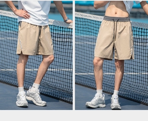 Detail of khaki cargo shorts showing elastic waist with drawstring and side slit
