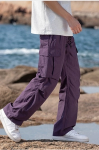 Close-up of purple lightweight cargo pants with side flap pocket and elastic drawstring