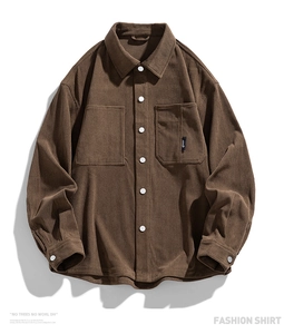 Macro detail of the corduroy texture and white snap buttons on this brown fashion shirt