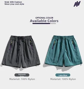 Detail of nylon summer shorts featuring elastic waistband with drawstrings and zip pockets