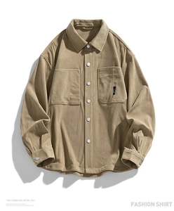 Detail of khaki corduroy shirt jacket with flap pockets and white button closure