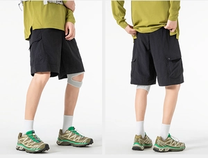 Detail of black tactical shorts featuring cargo pockets and durable quick-dry fabric