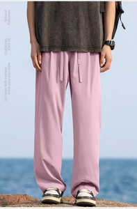 Close-up of lightweight purple hiking pants with drawstring at a scenic beach setting