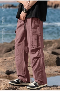 Men's outdoor cargo pants in rose pink featuring large side pockets and drawstring waist
