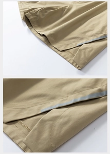 Detail of khaki cargo shorts showing side slit and reflective silver gray tape accent