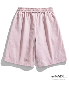 Detail of light pink casual shorts with elastic drawstring waist and water-repellent fabric