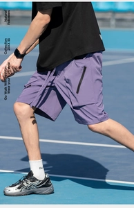 Detail of purple cargo shorts featuring drawstring waist and tactical side pockets