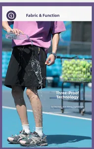 Water-repellent test on black sports shorts with purple zipper on a blue court