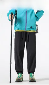 Blue hiking jacket with purple zippers and black outdoor trousers for camping gear