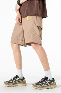 Detailed close-up of khaki cargo shorts with side flap pockets and durable ice-skin fabric