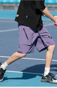 Detail view of purple quick-dry shorts with secure zipper pocket for outdoor tennis sports