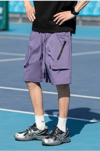 Detailed macro shot of purple cargo shorts featuring functional side pockets and zipper detail