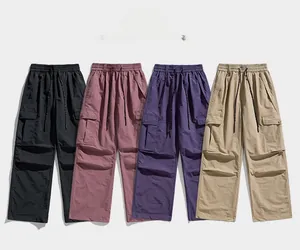 Detail view of cargo pants showing elastic drawstring waist and large utility pockets