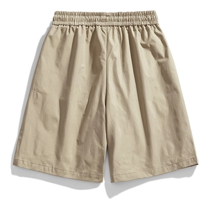 Detail of khaki water-repellent cargo shorts featuring an elastic waistband and flat fabric