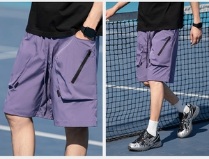 Detail of purple quick-dry cargo shorts featuring multiple pockets and elastic drawstring