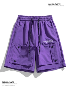 Detailed view of purple cargo shorts featuring water-repellent fabric and elastic drawstring